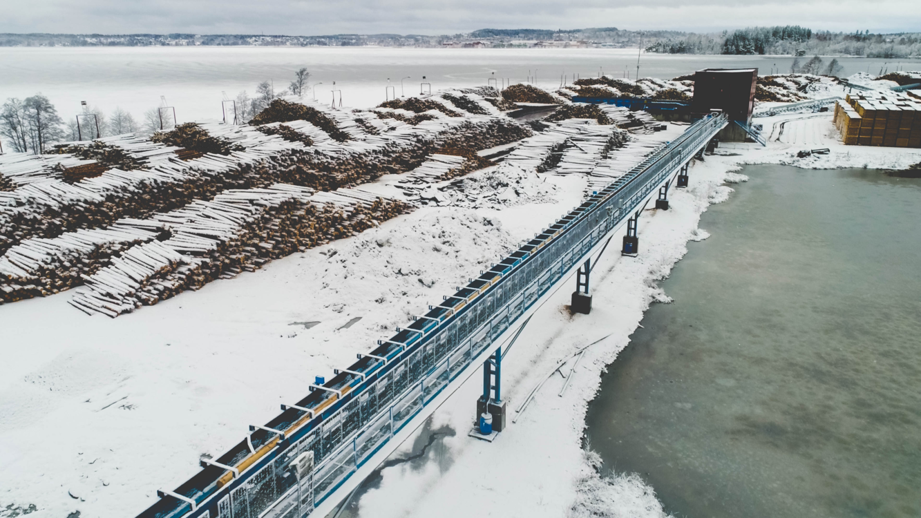 Snowy aerial view of a timber yard and conveyor system Snowy aerial view of a timber yard and conveyor system