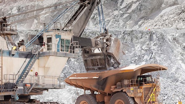 Electric rope shovel loading a dump truck in an open pit mine Electric rope shovel loading a dump truck in an open pit mine